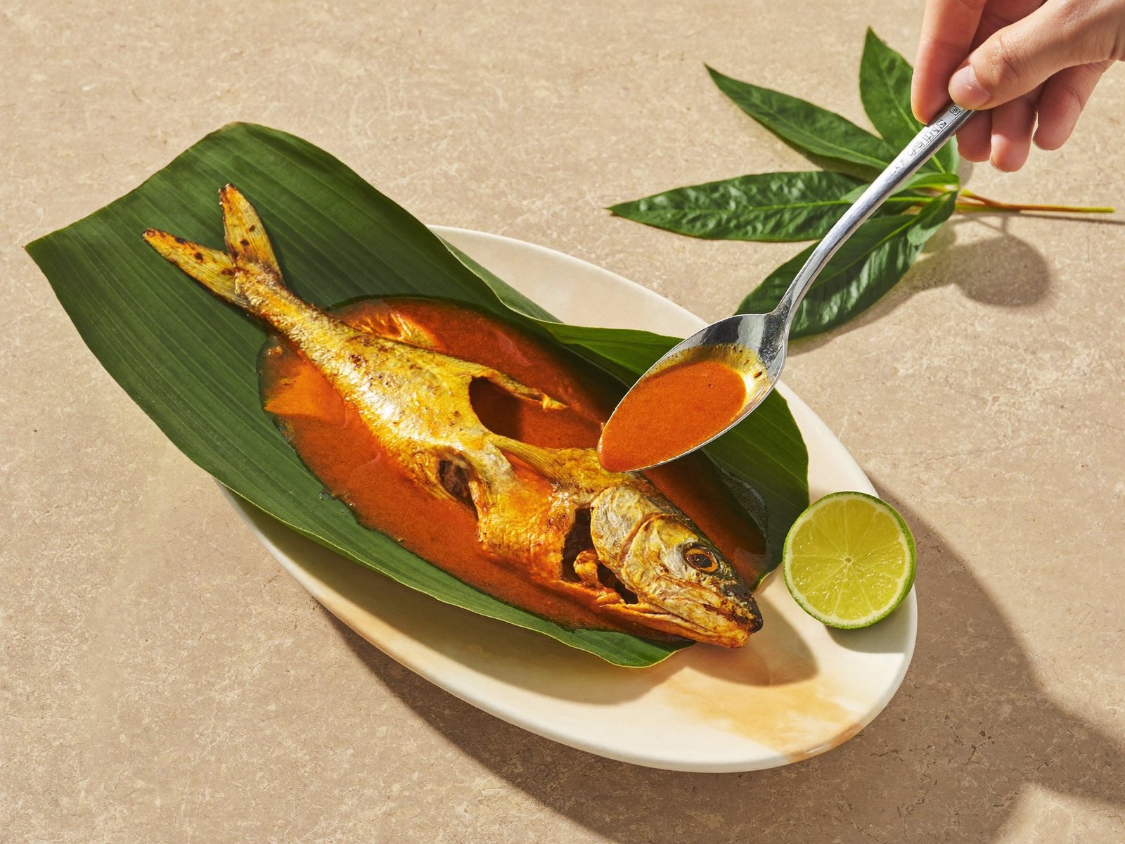 Karimeen pollichathu, pearl-spot fish roasted in banana leaf
